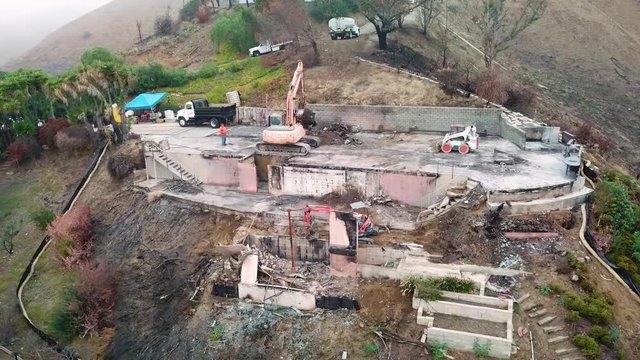 Aerial of a house being bulldozed on a hillside in Ventura following the destruction of Thomas Fire.