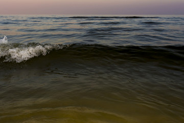 Obraz premium the night sea with waves and foam, sea sky after sunset time, nature abstract background