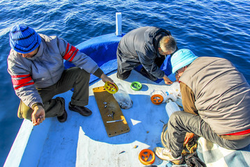 Izmir, Turkey, 10 December 2008: Fishermen on Sandal at Cesme