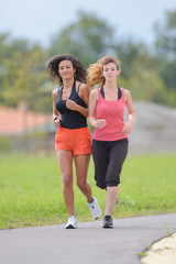 Two women jogging in park