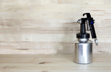 Spray painting is placed on a wooden table,copy space.