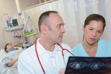 male and female doctor looking at patient xray