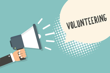Handwriting text Volunteering. Concept meaning Provide services for no financial gain Willingly Oblige Man holding megaphone loudspeaker speech bubble blue background halftone