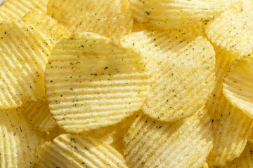 Handful of yellow potato chips