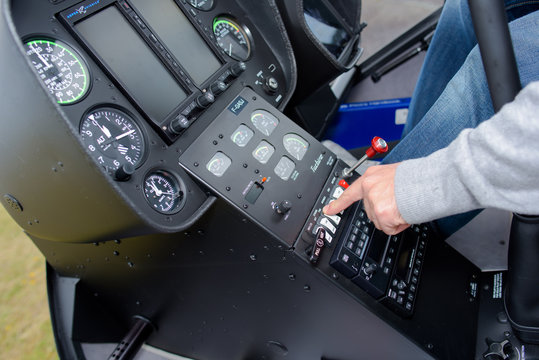 Man operating controls in cockpit
