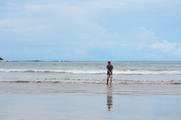 boy reflecting watching the sea