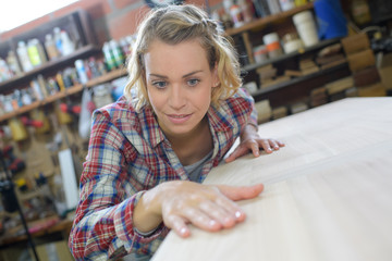 woman touching the surface of a plank wood