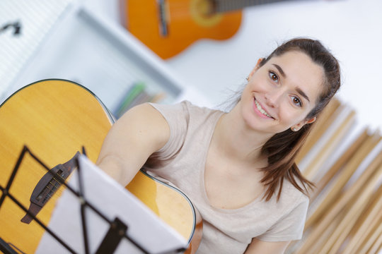 Portrait of young woman with guitar