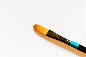 A new clean brush lies on white paper