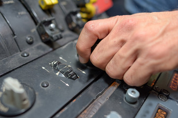 Closeup of hands on controls
