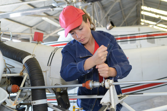 female engineer maintenance repairs airplaine