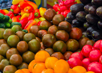 tomatoes, sweet peppers and aubergines and cucumbers, vegetables for sale at a market