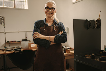 Portrait of confident senior female jeweler - Powered by Adobe