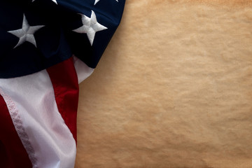 United States of America and American patriotism concept with close up on the the USA star and stripes flag with copy space on vintage brown aged blank paper