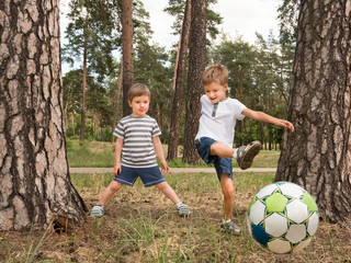 Children playing soccer outdoor. Leisure activities for children