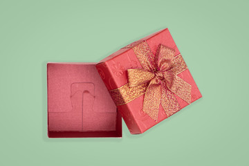 Top view of opened red gift box on green background. with copy space for text