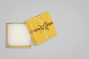 Top view of opened yellow gift box on glay background. with copy space for text