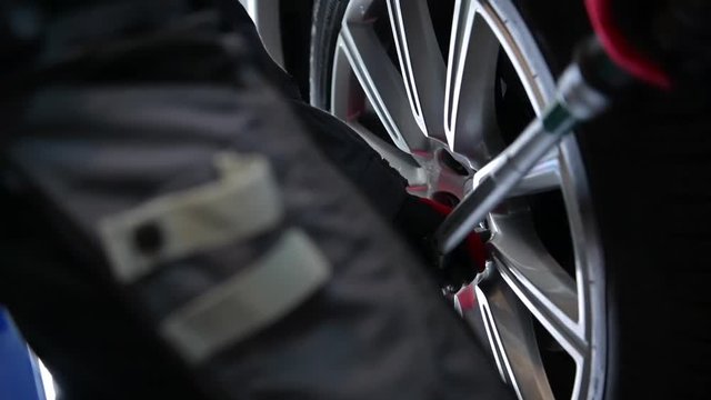 Car Mechanic Attaching Car Alloy Wheel. Auto Service Theme