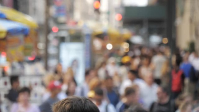 Out of focus New York City street people walking sidewalk