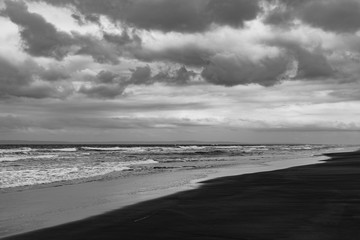 Black sand volcano beach on the ocean / sea coast.