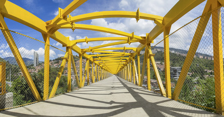 modern yellow pedestrian bridge, made of cement and steel