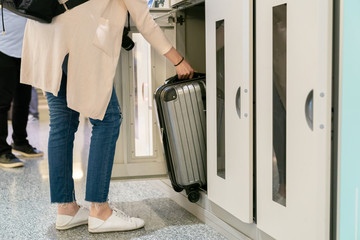 Fototapeta premium Putting the luggage in the locker.