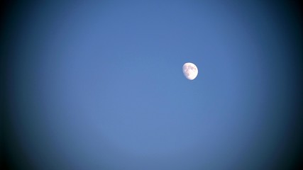 Moon in clear blue sky at morning time