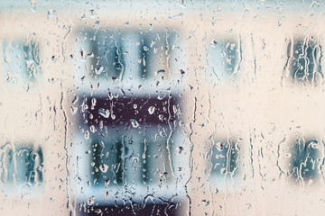 Raindrops on the window glass on the building background