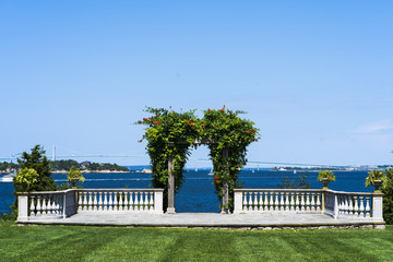 green lawn and arch with Newport Bay in background