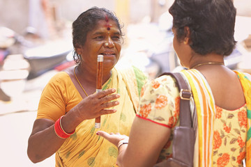 Indian female astrologer telling something to girl