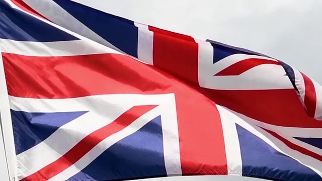 The United Kingdom flag waves in the wind in slow motion.