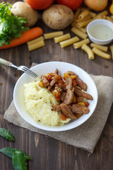 Soy meat with potato puree over kitchen table.