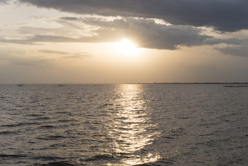 Golden light from sun in sunset time. Background of sunset at seascape.