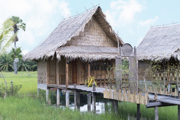 The vintage cottage in countryside. Wooden cottage in paddy field.