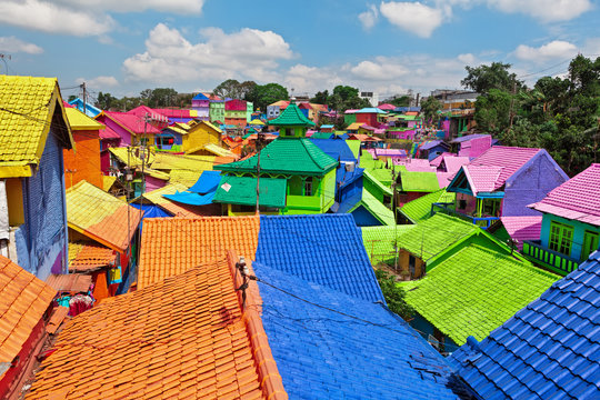 Panoramic view of old colorful houses village with tiled roofs painted in various colors. Popular place to visit for city tour on family holidays. Travel destination in Malang, East Java, Indonesia