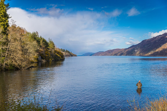 Man Fishing In The South End Of Loch Ness Lake In The Highlands Of Scotland