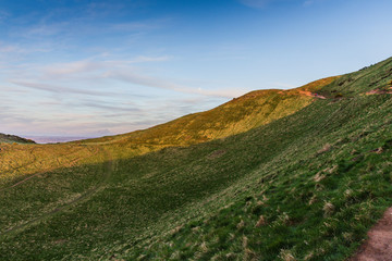 Green grass during summertime in Holyrood Park, Edinburgh, Scotland