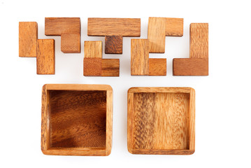 A wooden puzzle is a cube. Isolated on white background. Close-up.