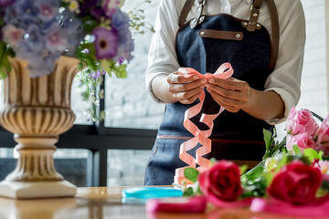 Woman hands making flower composition at florist workshop. Do it yourself concept