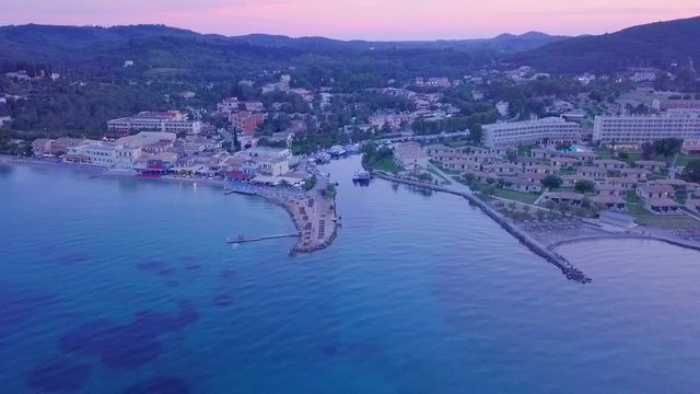 Greece, Corfu Island, drone footage of a beautiful sunset over Messonghi Beach. Orbit Shot.