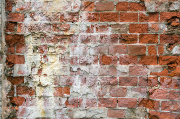 old severely damaged brick wall