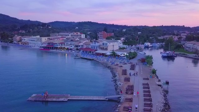 Greece, Corfu Island, drone footage of a beautiful sunset over Messonghi Beach. Orbit Shot Left.