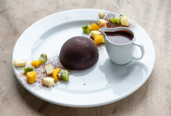 Chocolate cocoa dome dessert with slices fruits © Mumemories