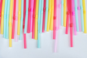 blue, pink and yellow straws for cocktails and other drinks isolated on white background