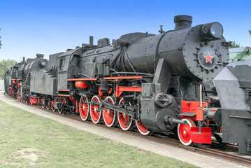 Plakat Steam locomotive with red wheels. Retro locomotive on rails.