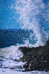 wave splashing against rocks