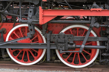 Fototapeta na wymiar Old steam locomotive. Detail and close up of huge wheels.