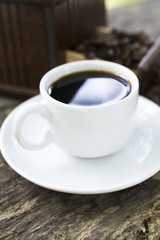 coffee grinder and cup with coffee with background