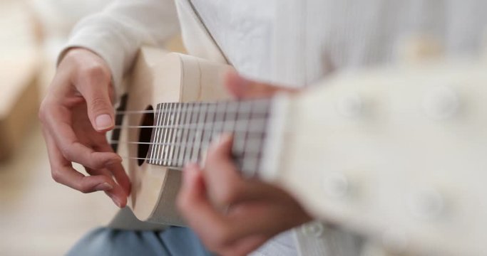 Woman practice on ukulele