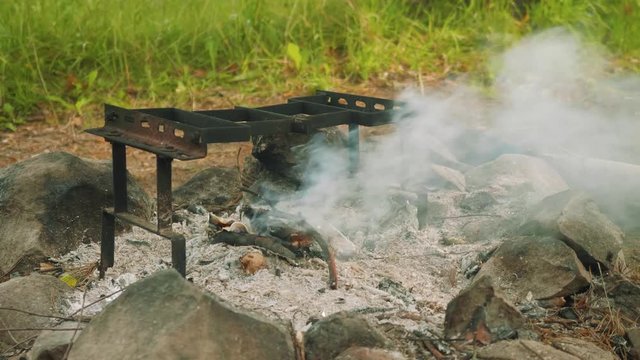 Camp fire remains with smoke